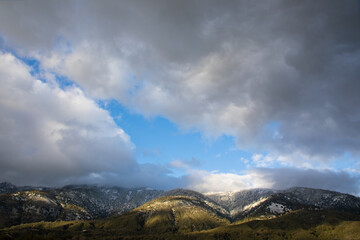 Scenic view of sunlight on winter snow fall and stormy winter clouds on Palomar Mountain in California 