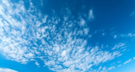 Naklejka na ściany i meble scattered clouds, blue skies
