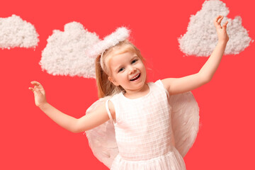 Cute little girl dressed as cupid with clouds on red background. Valentine's Day celebration