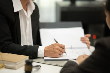 Partner lawyers or attorneys discussing a contract agreement. Successful businessmen have a contract in place to protect it,signing of modest agreements form in office...