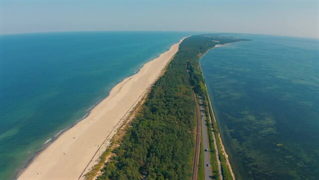 Top drone view above the Hel penisula in Poland with beach, sand and baltic sea in the background at sunny summer day