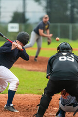 Obraz premium Men playing baseball game. Batter getting ready to hit a pitch during ballgame on a baseball diamond