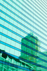 High-rise modern building made of glass against the sky.