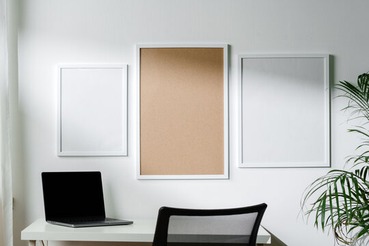 Empty frames on the wall above the working table in the office