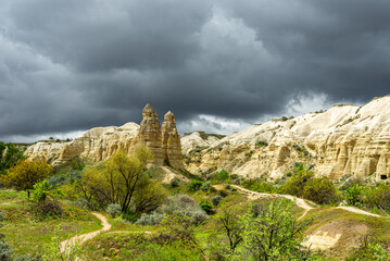 Unique geological formations in the Valley of Love in Cappadocia with a stormy sky