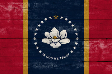 Mississippi State flag on a wooden surface. Banner of the grunge Mississippi State flag.