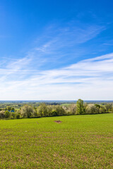 Fototapeta premium Landscape view from a green field in the spring