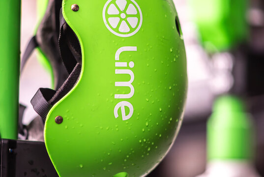 Melbourne, Victoria, Australia, April 16, 2023:  A green helmet used by the Lime electric scooter company is covered in water droplets after a rain shower