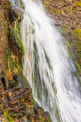 Splashing water in a waterfall on a rock