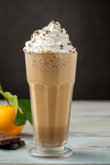 Orange and chocolate milkshake with coffee sprinkled on top