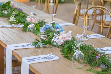 Beautiful flowers decorated on the table.Tables set for an event party or 
wedding reception....