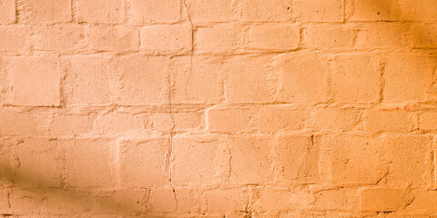 old wall Peach Fuzz beige background with old facade bricks