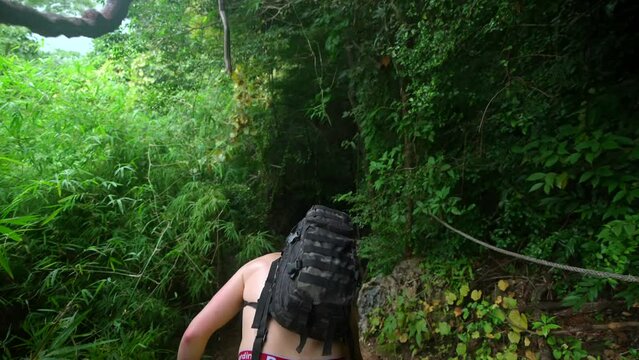 footage a model man walking in the jungle from Railay beach in Krabi Thailand footage of incredible Thai landscapes incredible nature with insane rocks, jungle. Filmed in 4k with smooth movement