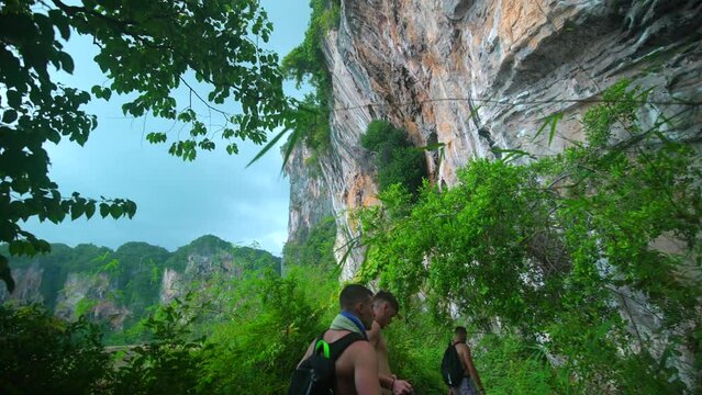 footage a model man walking in the jungle from Railay beach in Krabi Thailand footage of incredible Thai landscapes incredible nature with insane rocks, jungle. Filmed in 4k with smooth movement