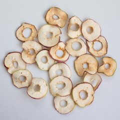 Dried apple rings snack sprinkled with cinnamon on white background. top view. content for a blog about healthy nutrition. Copy space