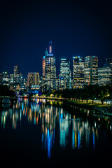 Fototapeta na wymiar Illuminated downtown city buildings at night in Melbourne, Australia.