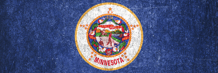 Close-up of the grunge Minnesota State flag. Dirty Minnesota State flag on a metal surface.