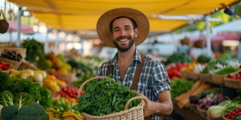 Happy young countryman with a basket in hand showing vegetables and looking at the camera at a local market - obrazy, fototapety, plakaty