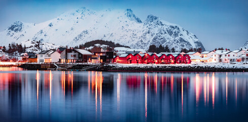 Beautiful winter scenery. Red wooden houses on Ballstad port, Norway, Europe. Spectacular spring...