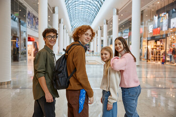 Group of young friends shopping at big city store center