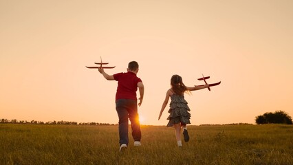 happy boy girl child play airplane pilot sunset, children family dream flying, moment childhood,...