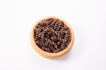 Organic cooked Buckwheat Fusilli pasta on white background. Wholegrain gluten free noodles. Healthy food concept