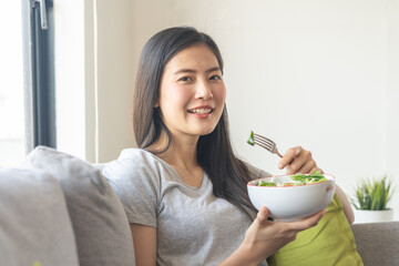 eat healthy food on wellness lifestyle. Beauty young woman eating salad as a breakfast.