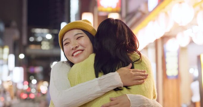 Japanese women, hug and friends in city for travel, bonding and care on weekend vacation in street. People, happy and embrace in tokyo town on holiday, wellness and relax together for social on road