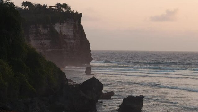 View of beautiful blue crashing ocean waves in Uluwatu, Bali