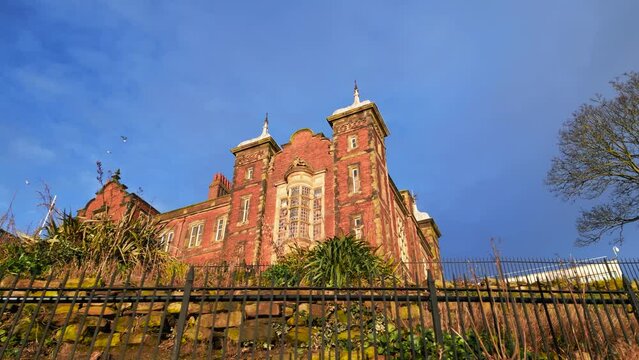 Cinematic shot of Nottingham High Schol Boys surrounded by a fence  with a clear sky in England, UK.
