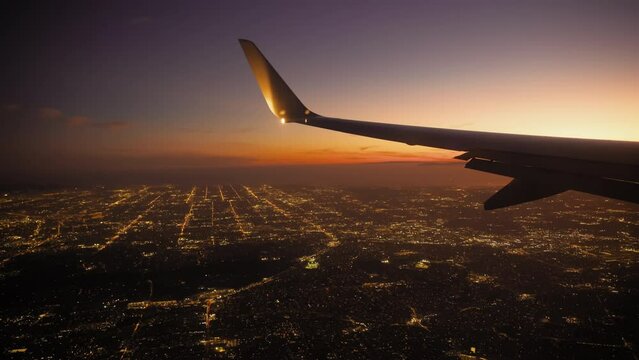 Airplane Jet plane prepare to landing in Los Angeles LAX airport. Porthole view with wing. Slow motion