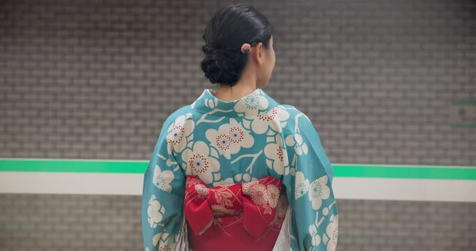 Japanese woman, back and train station to travel in fast bullet and traditional clothes on platform. Person, subway and kimono fashion in tokyo city and waiting on metro transport with motion blur