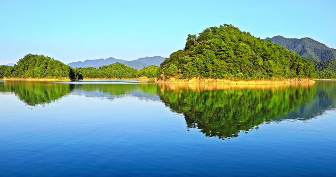 Clear lake water and green island with mountain natural landscape in Hangzhou. Fixed camera shooting. 