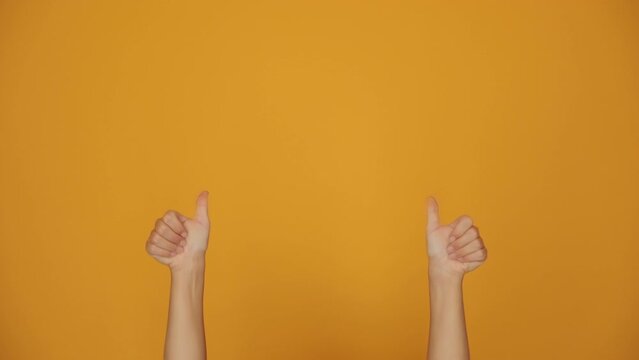 Thumbs up for likes. Hands gesturing like on orange background.