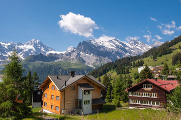 Fototapeta na wymiar Summer serenity in Gimmelwald, Switzerland. A mesmerizing view of the Bernese Alps from this charming Oberland village