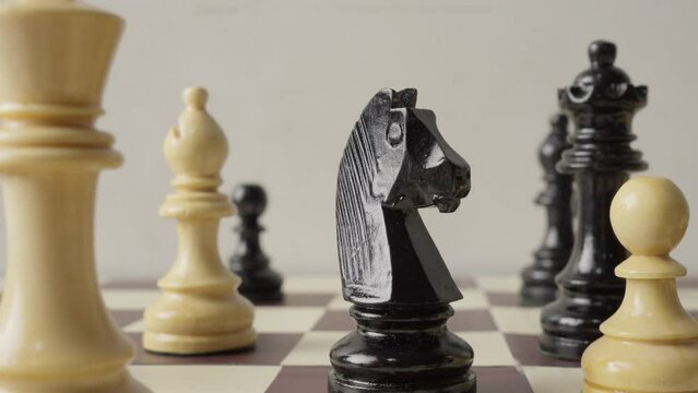 Closeup of chess board as knight takes center stage in captivating rack focus