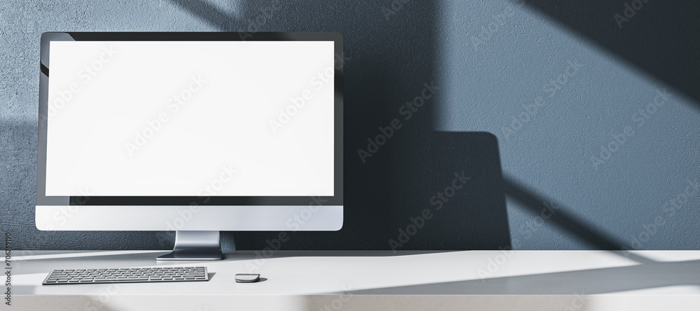 Aufkleber Modern designer office desktop with empty white mock up computer monitor, supplies and other items on wide gray wall background. 3D Rendering.