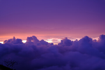 Taking photos of clouds from a height above a mountain peak