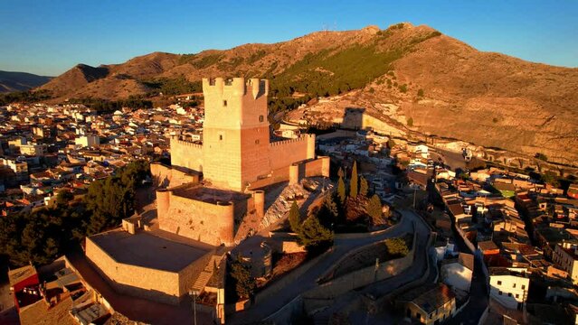 Scenic medieval towns and castles of Spain - Castillo de la Atalaya in Alicante province. Spanish historic landmarks. aerial drone 4k hd footage over sunset