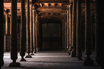 Interior inside the ancient Juma mosque with wooden carved mosaic columns, in the ancient city of...