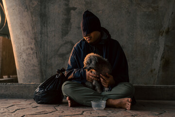 Homeless man and dog on the street waiting for help food and money from people volunteer foundation donate. Poor tired stressed depressed hungry homeless man