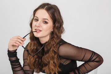 girl model in black shirt trousers posing relaxed in studio on white background