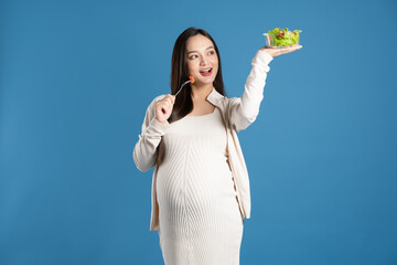 Portrait of pregnant asian woman, isolated on blue background