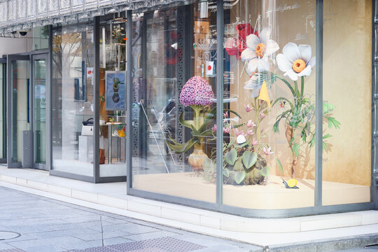 TOKYO, JAPAN - December 30, 2023: Front of Maison Hermes Ginza in Tokyo with a botany-themed window display.