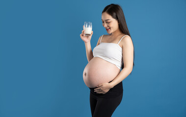 Portrait of pregnant asian woman, isolated on blue background