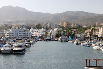 Fototapeta na wymiar Boats and yachts moored at Puerto Marina in Benalmadena, Costa del Sol Malaga, Spain. This marina has berths for 1100 boat