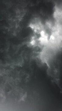 Dark storm clouds are moving fast, timelapse. Vertical video 4k