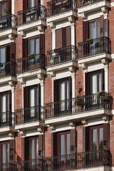 Traditional building facade. Downtown in Madrid. Red bricks. Spain