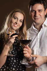 Young happy couple enjoying a glasses of wine