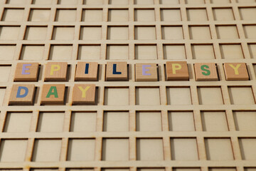 Inscription Epilepsy Day in wooden letters on a wooden background
